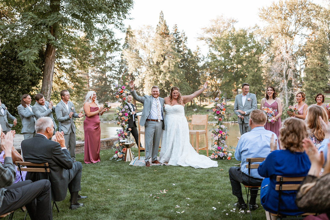 Happy Wedding Couple Just Married with crowd cheering