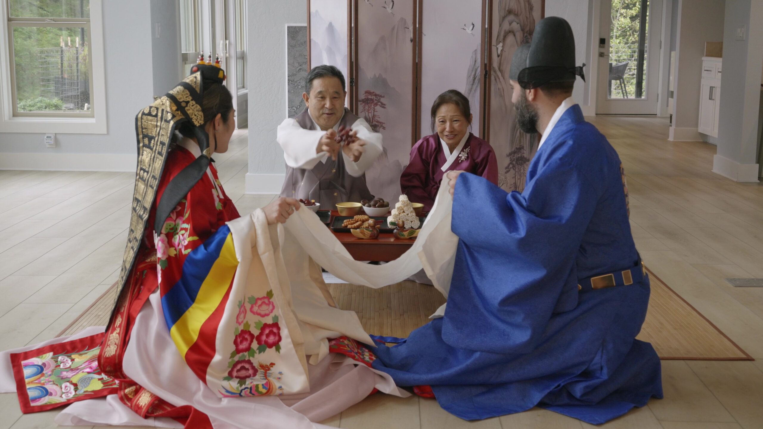 Paebaek Wedding Ceremony Date Toss Dad throws dates for wedding couple to catch in a sheet during traditional Korean Paepaek Wedding Ceremony at Crook Point Mervue Estate
